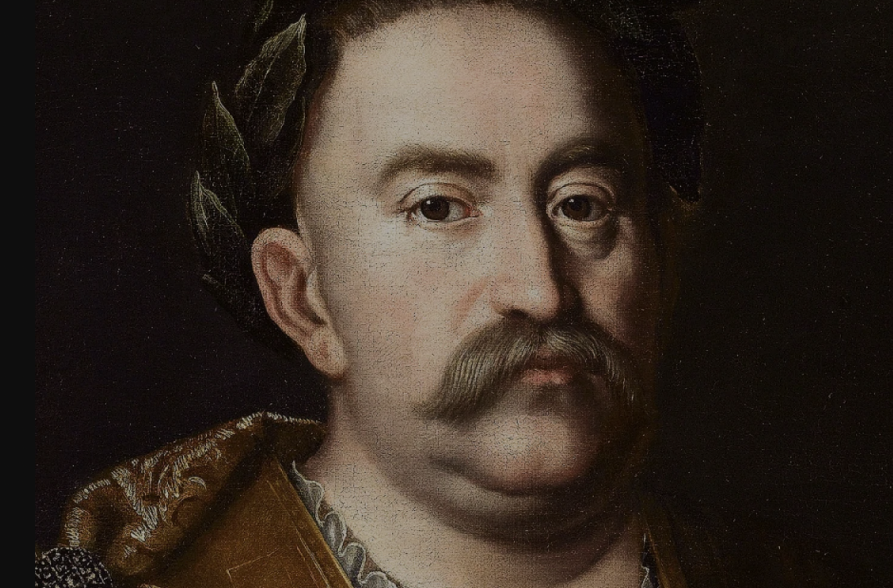 Portret olejny króla Jana III Sobieskiego. Król patrzy poważnie przed siebie. Ma na głowie wieniec laurowy.